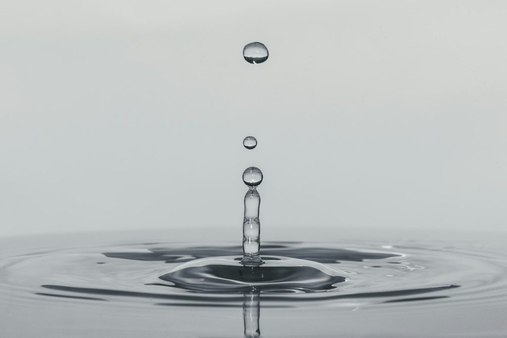 A drop of water falling into water