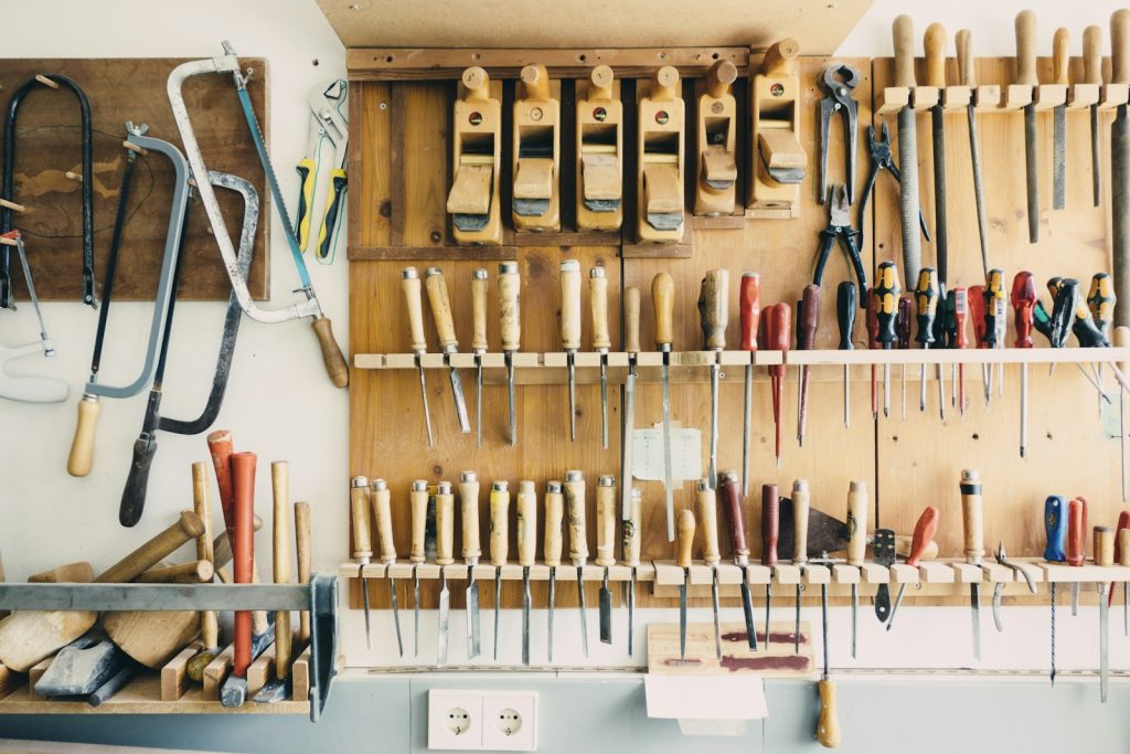 Assorted hand tools hanging on a tool rack